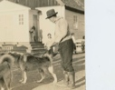 Image of Assistant Governor Rasmussen and dogs in front of church